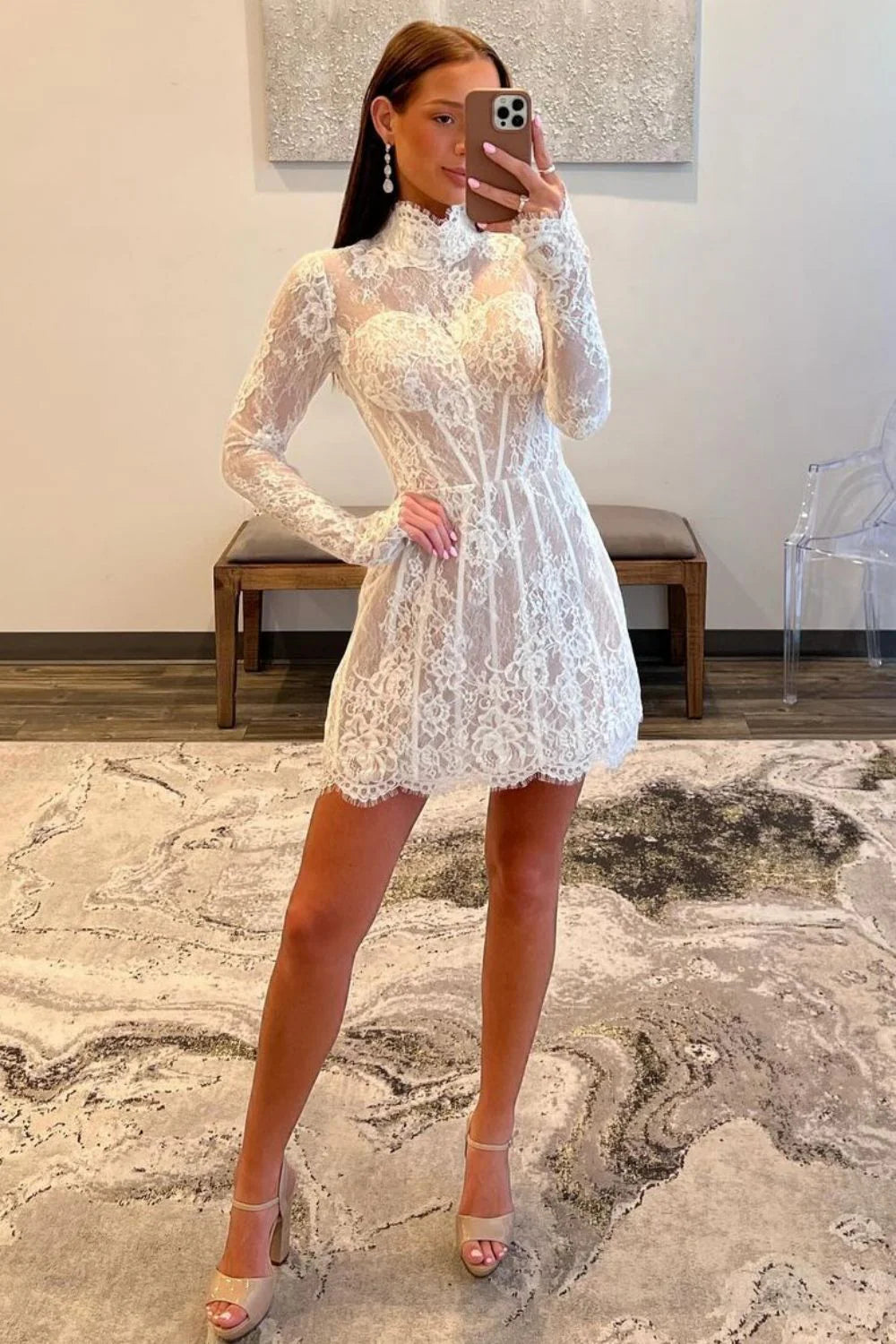 Close-up of lace detail on white high neck dress sleeve.