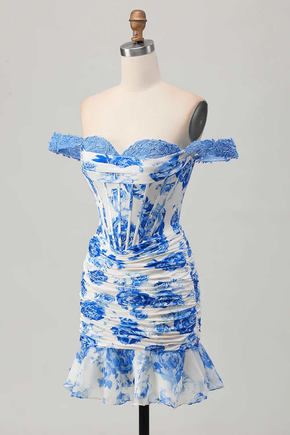 Close-up of the blue floral pattern and corset detail on the white homecoming dress.