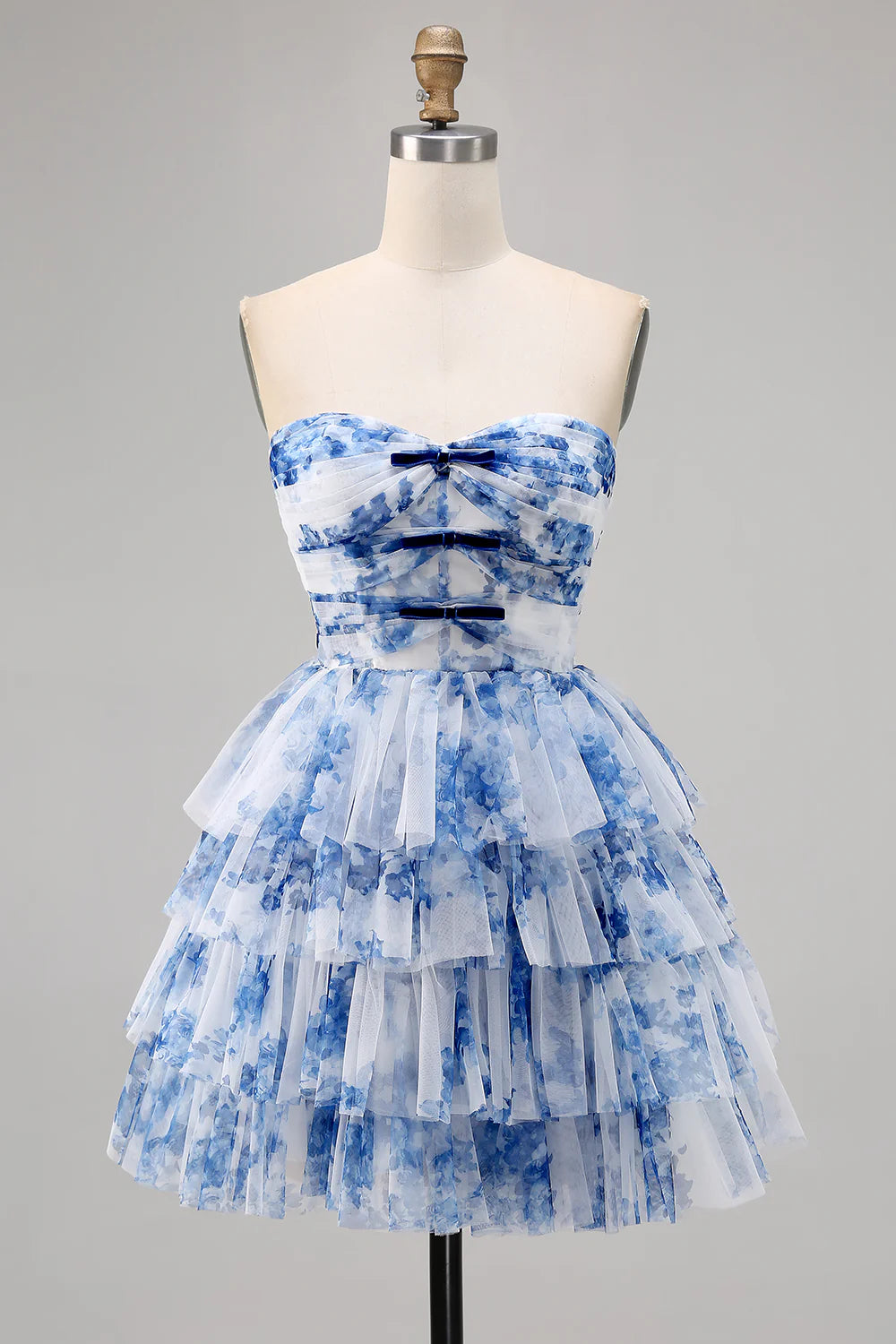 White and blue floral strapless A-line short homecoming dress on a model.