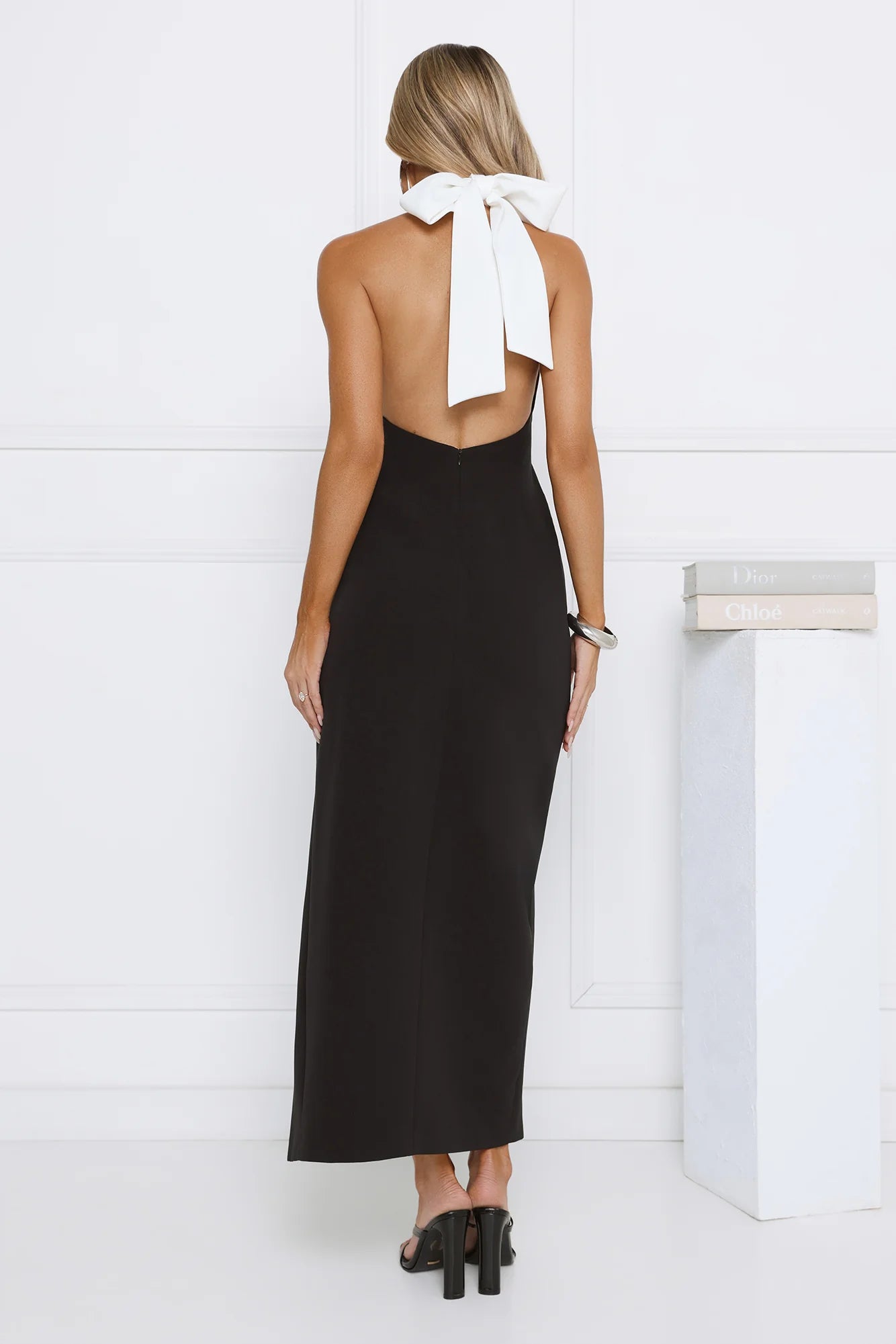 Elegant Black Halter Maxi Dress with Contrast White Bow Collar, Open Back, High Thigh Slit and Form-Fitting Silhouette