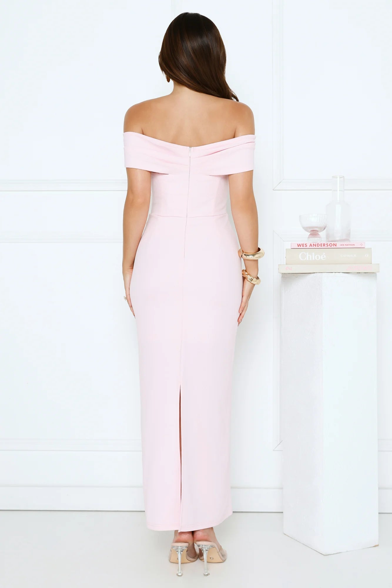 Elegant Blush Pink Off-the-Shoulder Maxi Dress with Bow Accent, Form-Fitting Bodycon Silhouette, Back Slit and Structured Crepe Fabric
