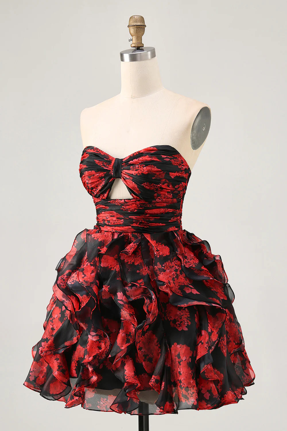 Close-up of the black and red floral pattern and ruffled details on the strapless homecoming dress.
