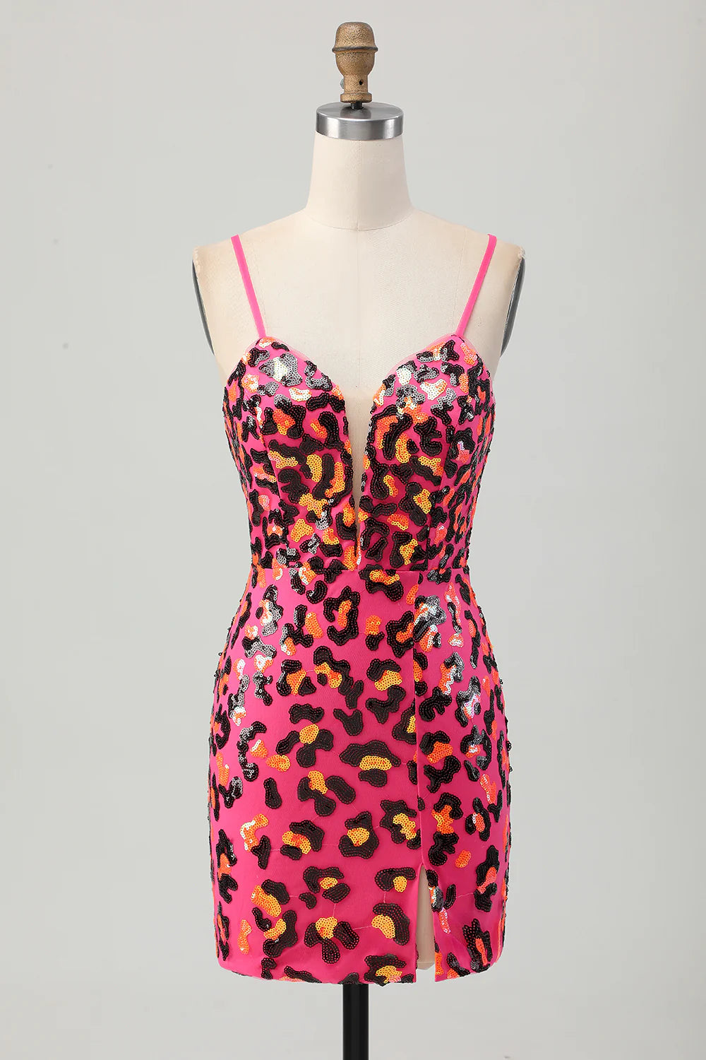 Model wearing fuchsia leopard sequin mini homecoming dress with spaghetti straps and a side slit.