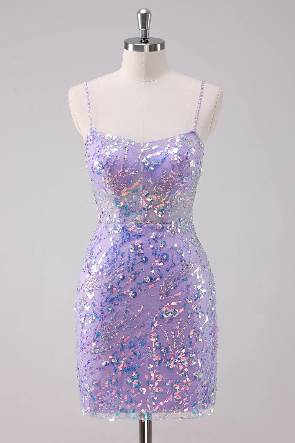 Model wearing a sparkly purple bodycon short homecoming dress with spaghetti straps and sequins.