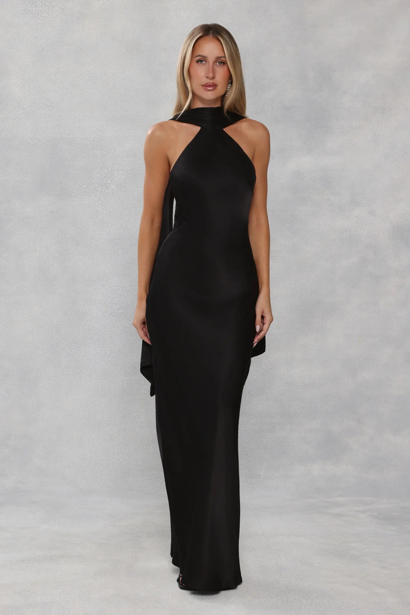 Glamorous Black Satin Halter Neck Maxi Dress with High Neck Draped Cape Overlay, Open Back Tie Closure, Form-Fitting Mermaid Silhouette and Floor-Length Flowing Skirt