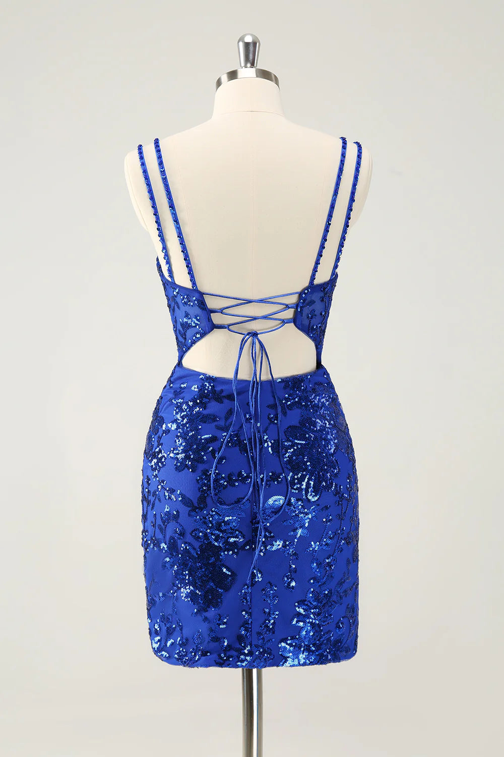 Back view of a glitter royal blue short homecoming dress with lace-up detail.