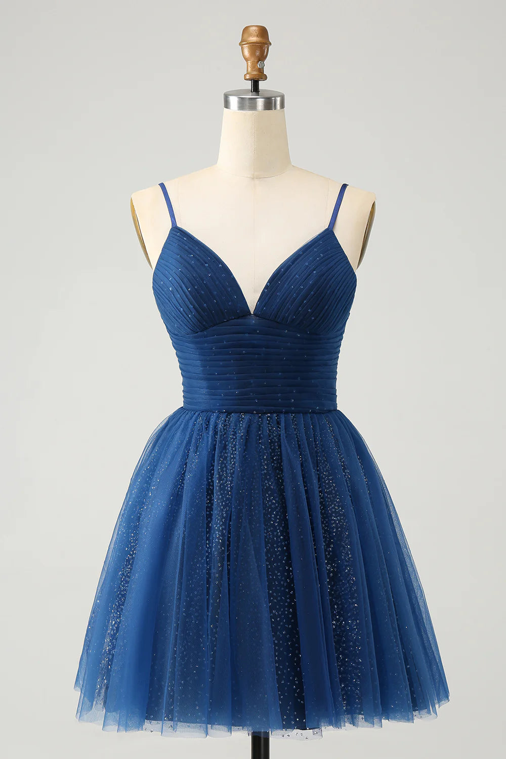 Glitter navy A-line homecoming dress with spaghetti straps and pleated tulle.
