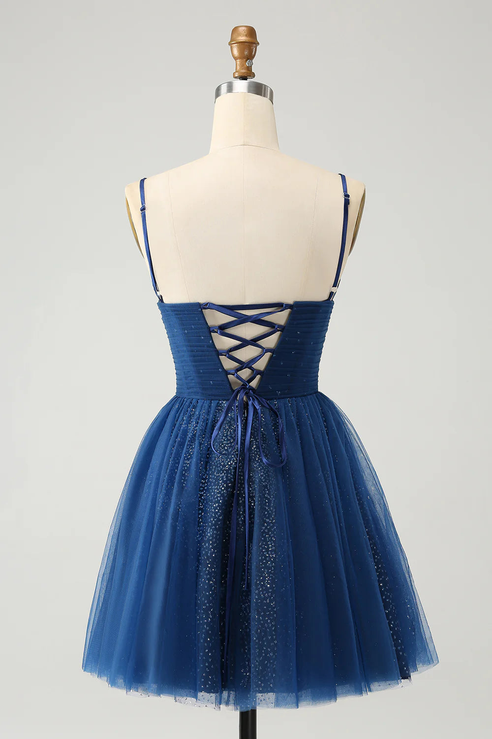 Back view of navy sequined homecoming dress with pleated tulle skirt.
