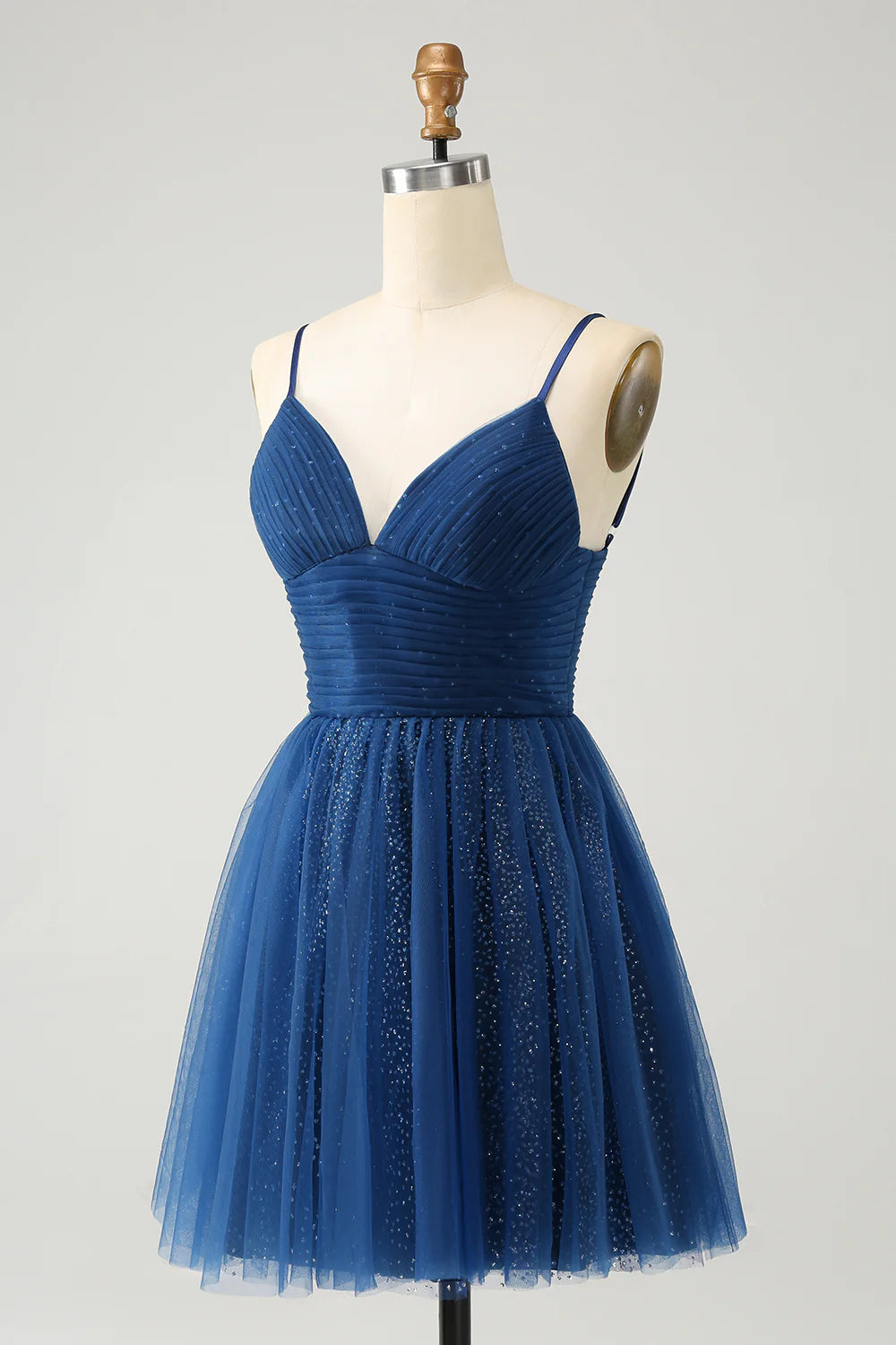 Side view of short navy glitter dress featuring spaghetti straps and A-line silhouette.