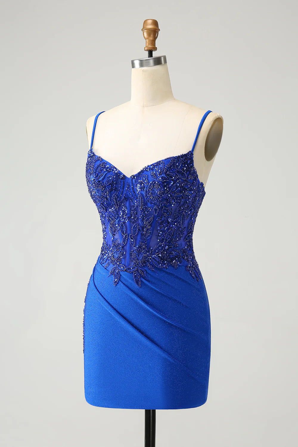 Back view of royal blue glitter A-line dress, highlighting corset lacing.