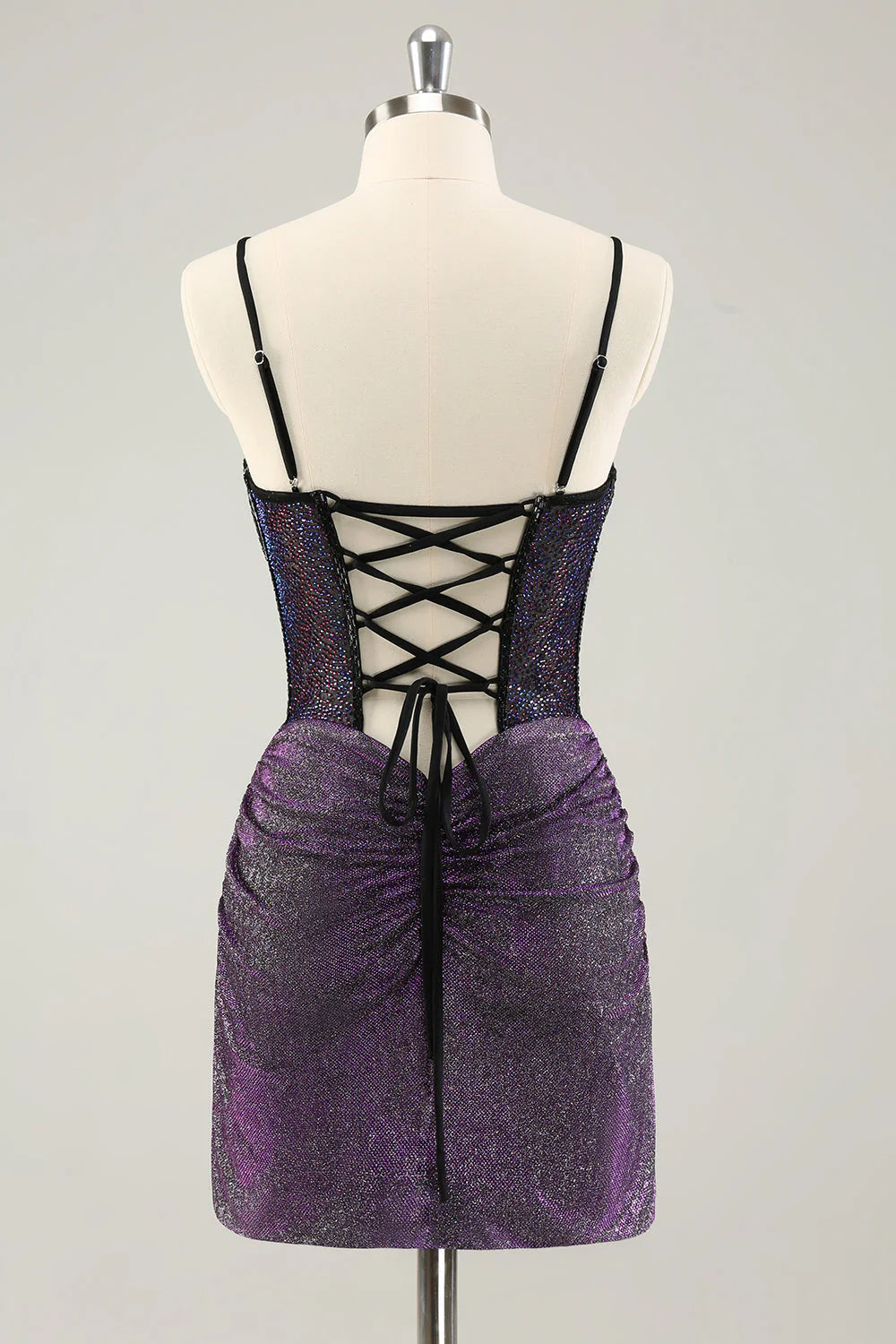 Back view of dark purple short homecoming dress featuring a lace-up corset.
