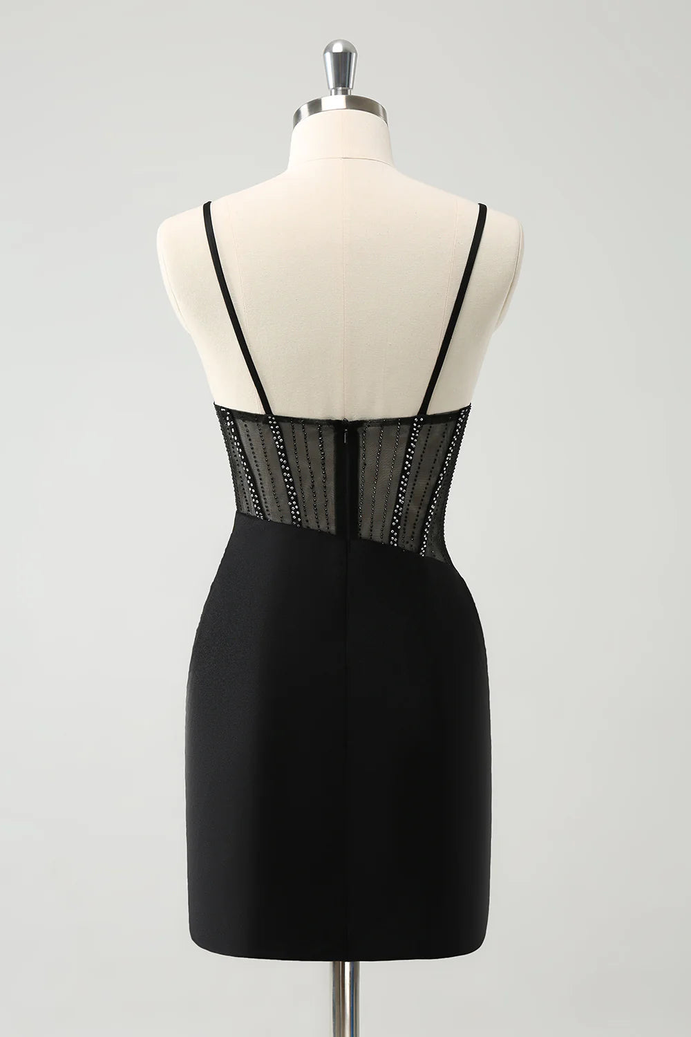 Side view of a model in a glitter black short homecoming dress, showcasing the tight fit and spaghetti straps.