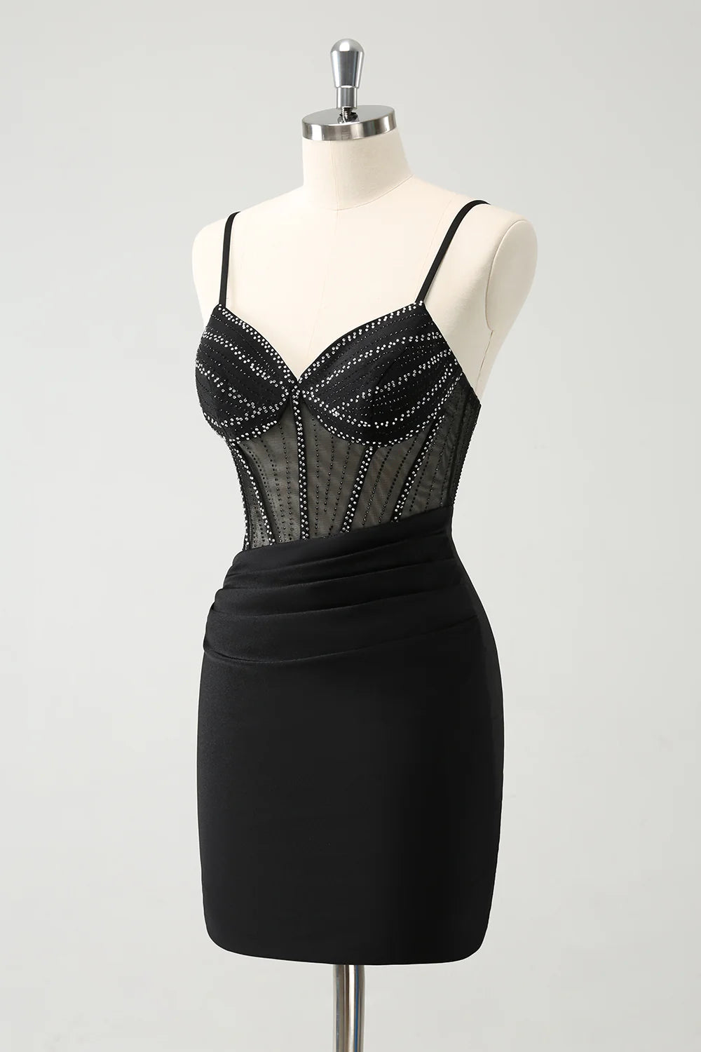 Back view of a model wearing a glitter black short homecoming dress, highlighting the corset detailing.