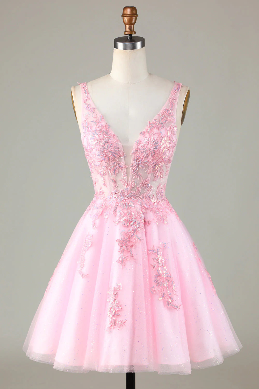 Full view of a glittering pink sequin short backless homecoming dress with appliques.
