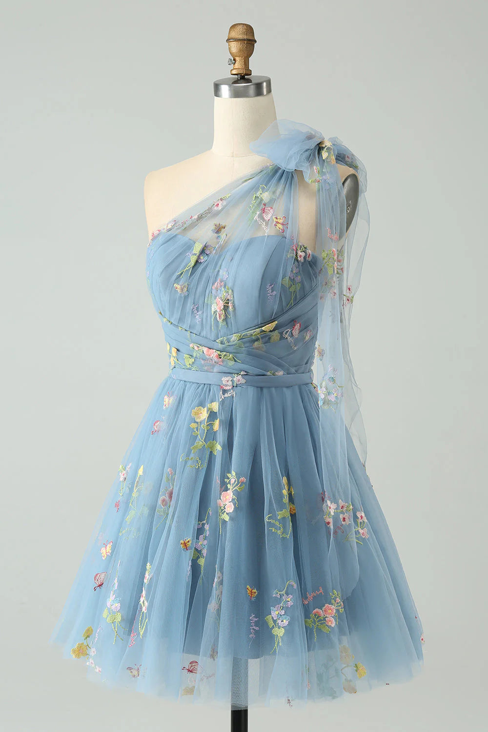 Side view of the grey blue A-line one-shoulder tulle dress, showcasing the silhouette.