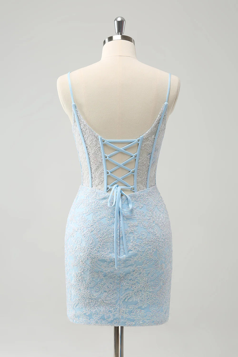 Side view of the light blue corset spaghetti strap short homecoming dress.