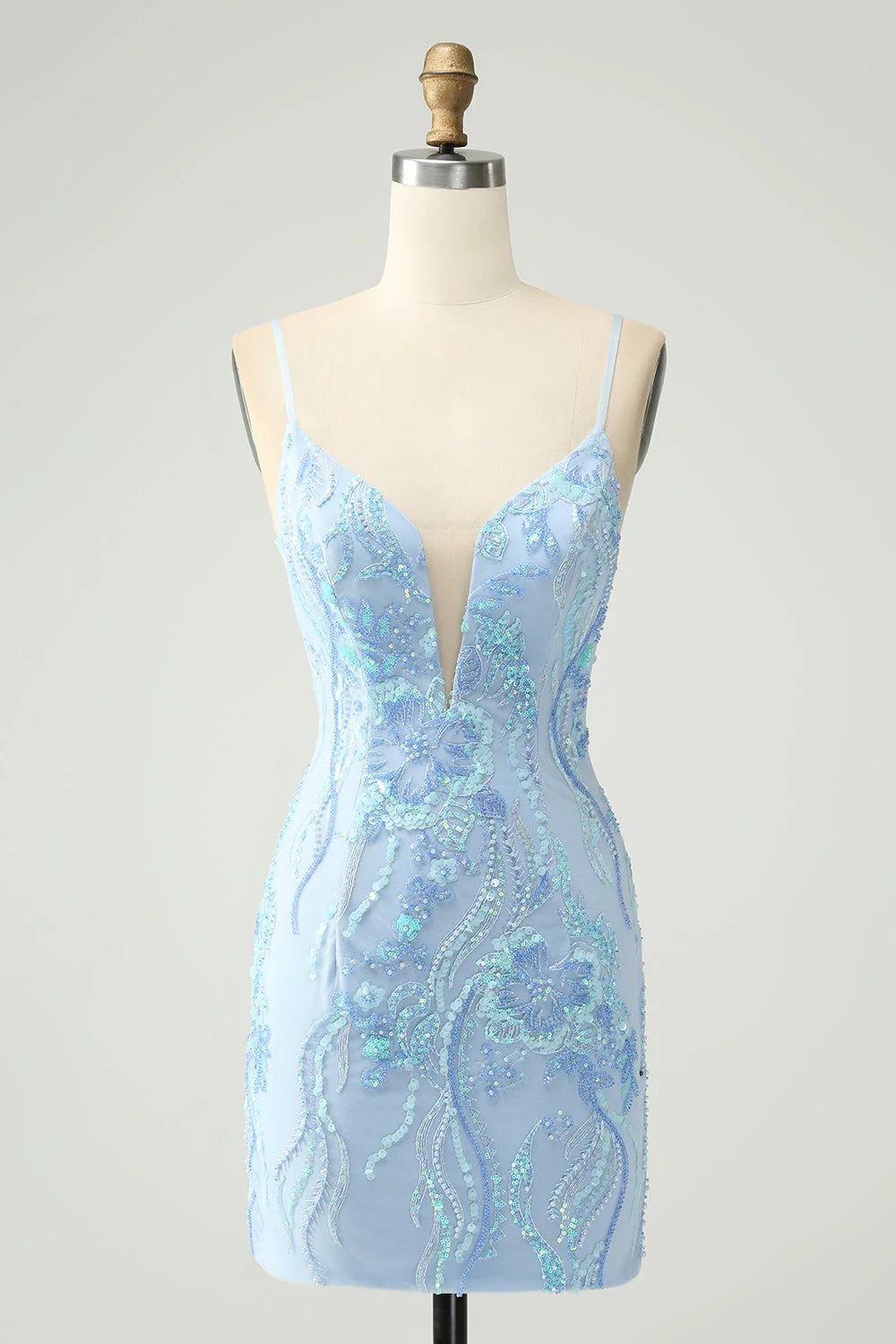 Model wearing a light blue sequin spaghetti strap short homecoming dress.
