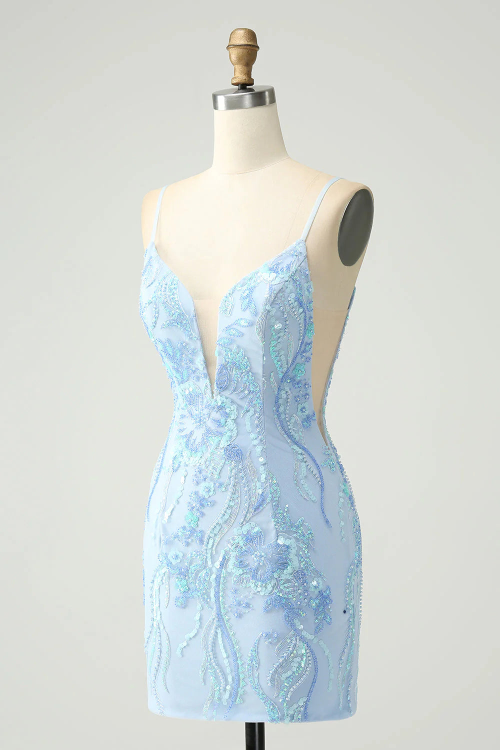 Close-up of the shimmering light blue sequin fabric on a short dress.