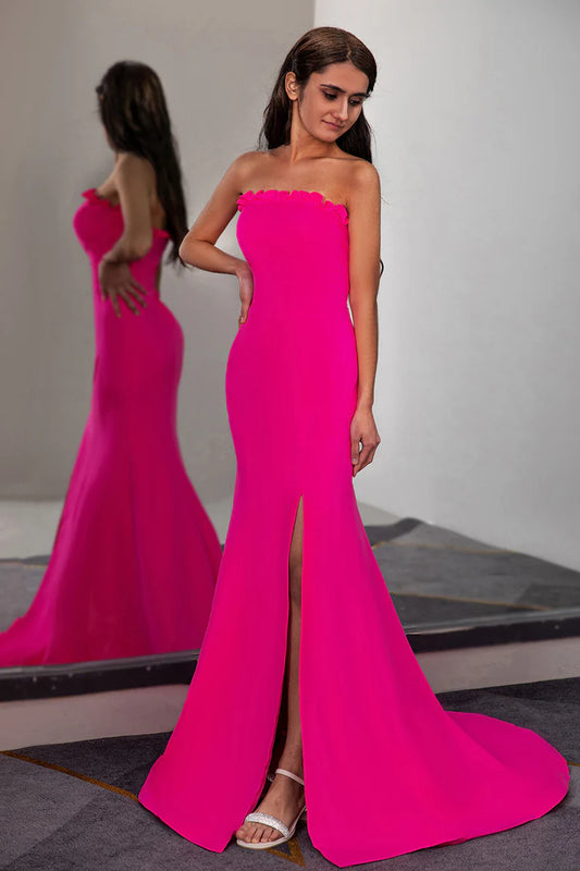 A fitted pleated waist cinched strapless side slit ball dress