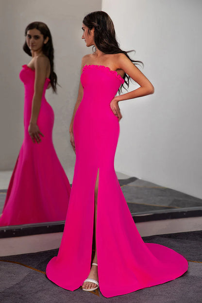 A fitted pleated waist cinched strapless side slit ball dress