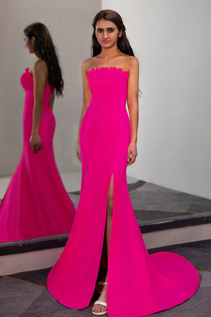 A fitted pleated waist cinched strapless side slit ball dress