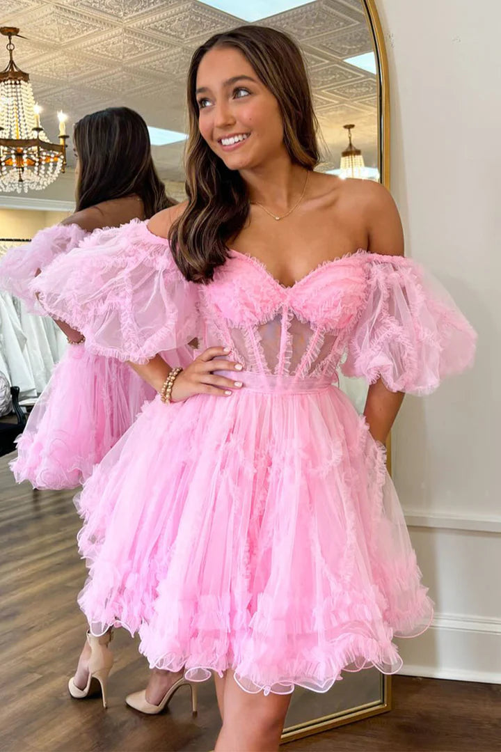 Pink A-line tulle homecoming dress with V-neck and long sleeves.