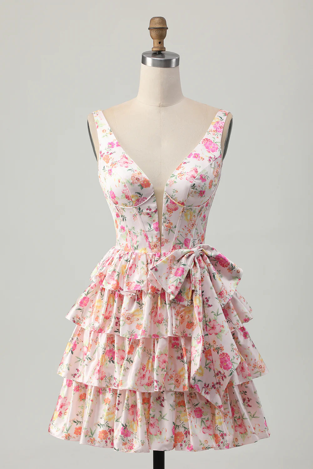 Pink floral A-line tiered homecoming dress with a bow, front view.