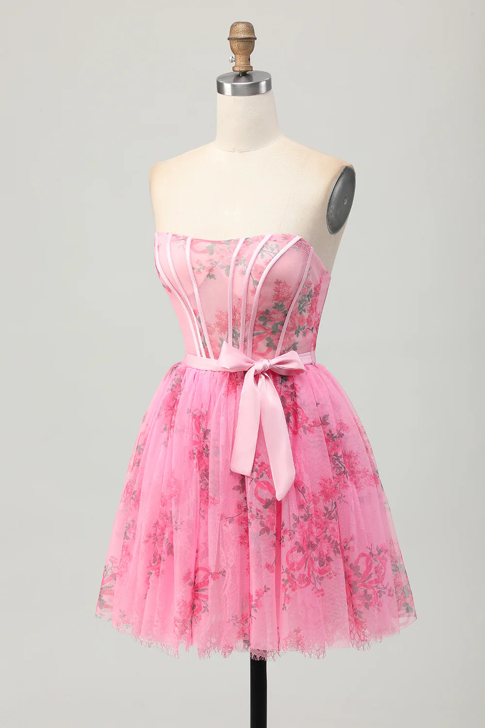 Close-up of flower appliques on pink strapless homecoming dress.