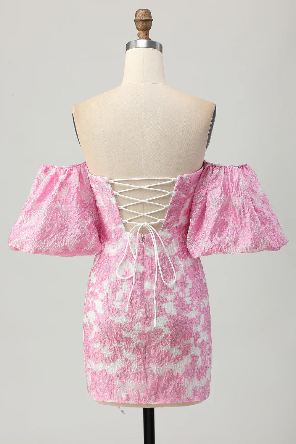 Back view of pink printed homecoming dress with lace-up detail.
