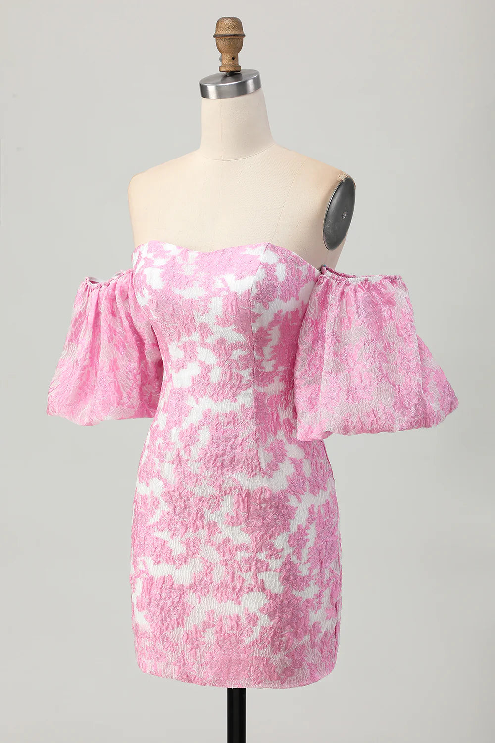 Side profile of model wearing pink printed strapless dress.