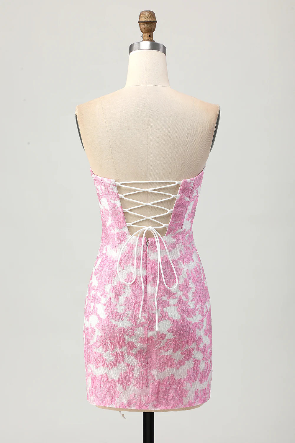 Model showcasing the elegant pink strapless dress with removable sleeves.
