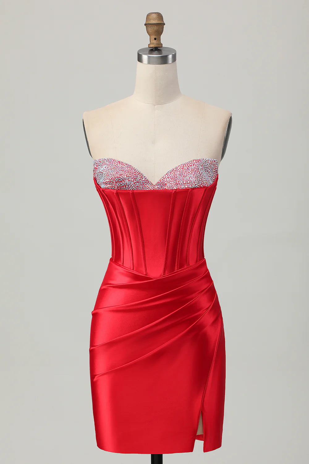 Front view of a model wearing a red bodycon strapless satin short homecoming dress with a thigh-high slit.