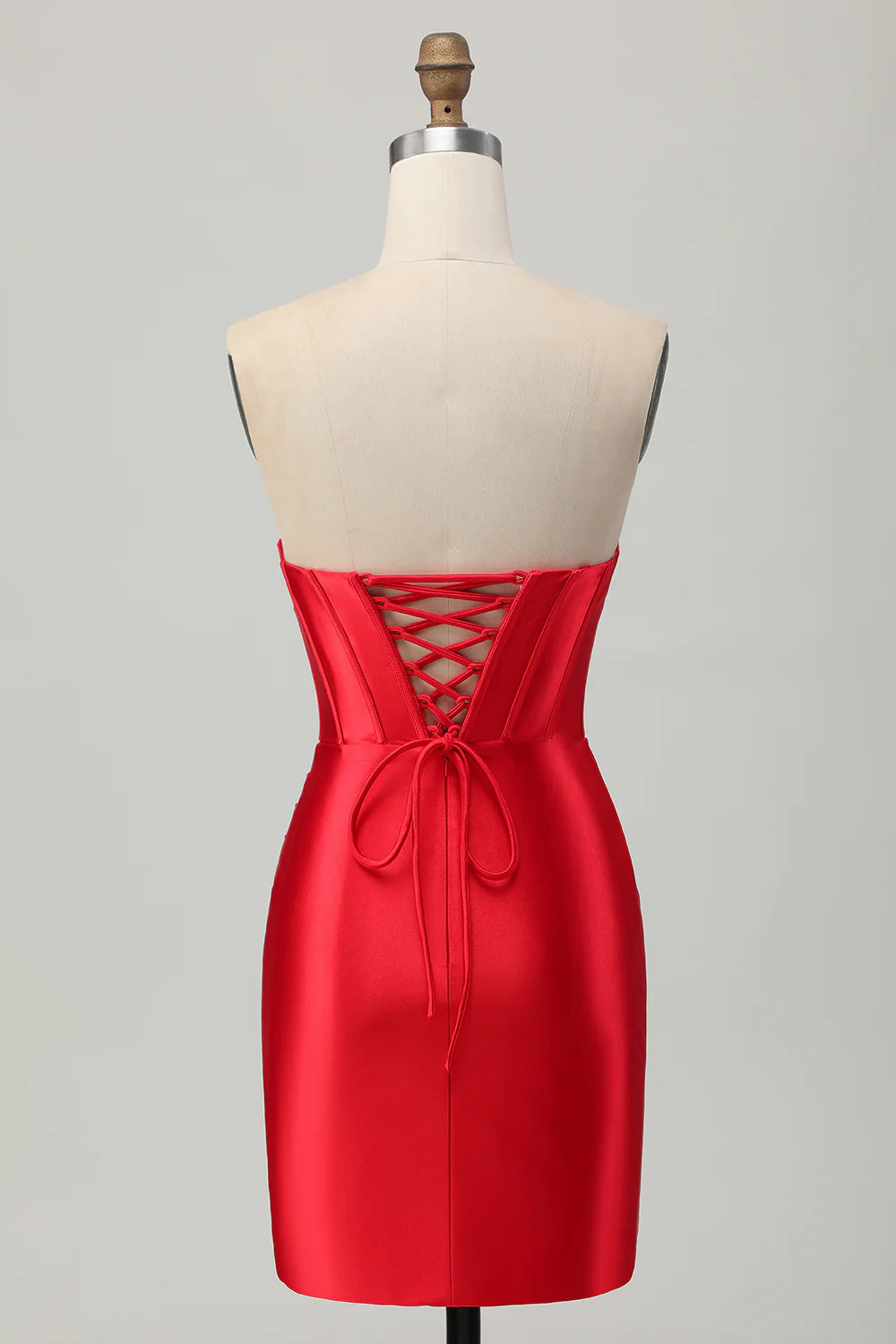 Side view of a model in a red bodycon strapless satin short homecoming dress, showcasing the corset detail.