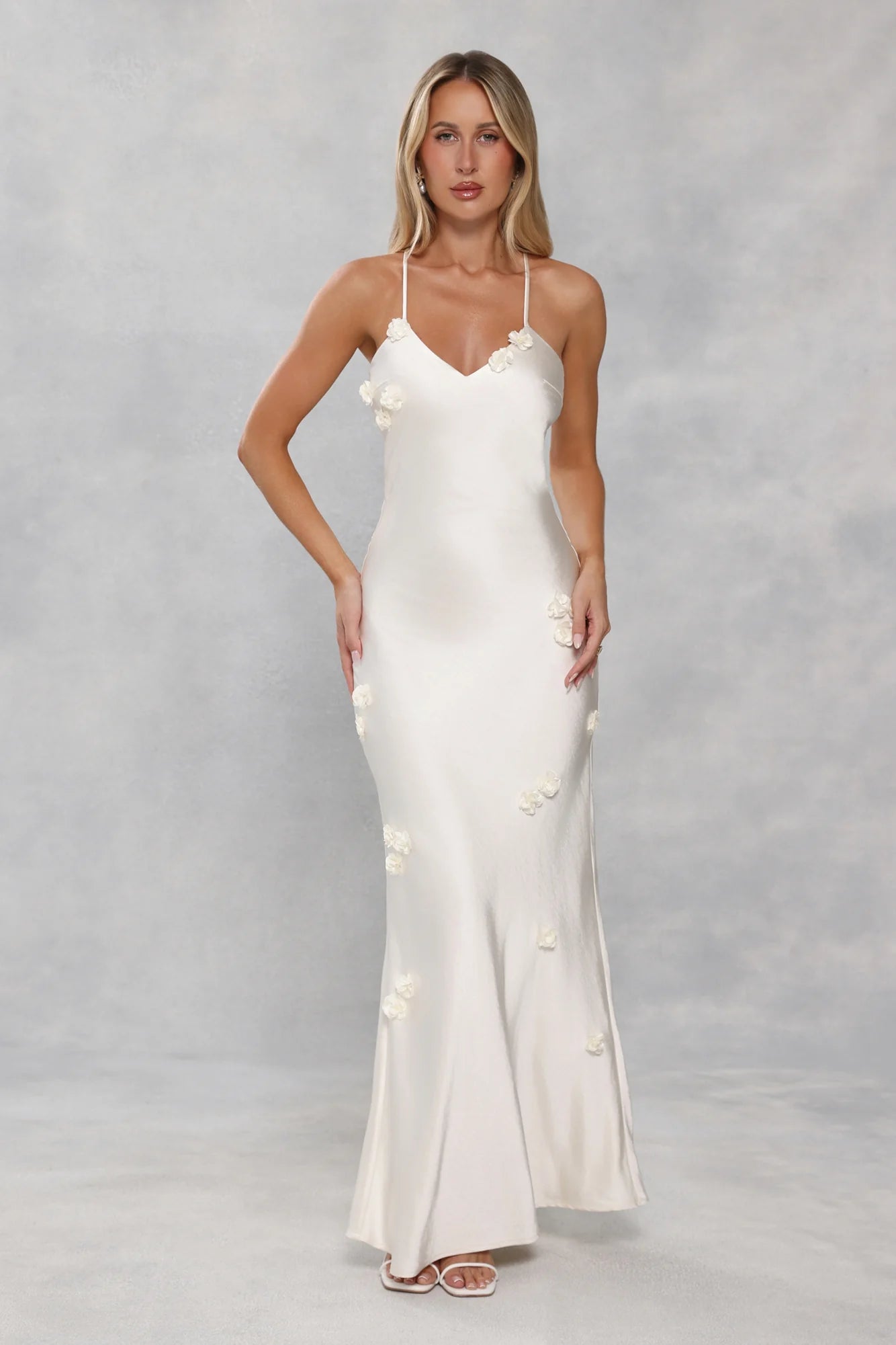 Romantic Ivory Satin Maxi Dress with 3D Floral Appliqués, Crisscross Strappy Open Back and Form-Fitting Silhouette