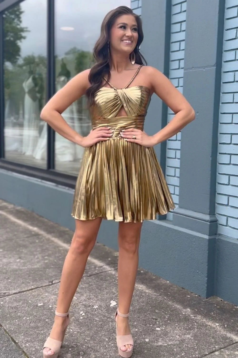 Side view of gold metallic A-line halter neck short dress.