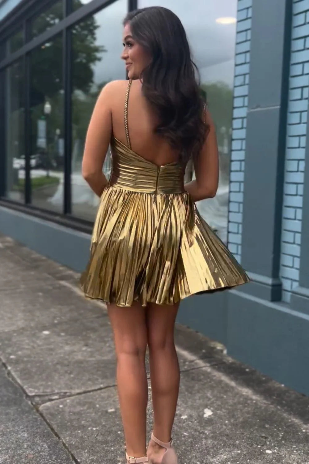 Close-up of metallic fabric on gold homecoming dress.
