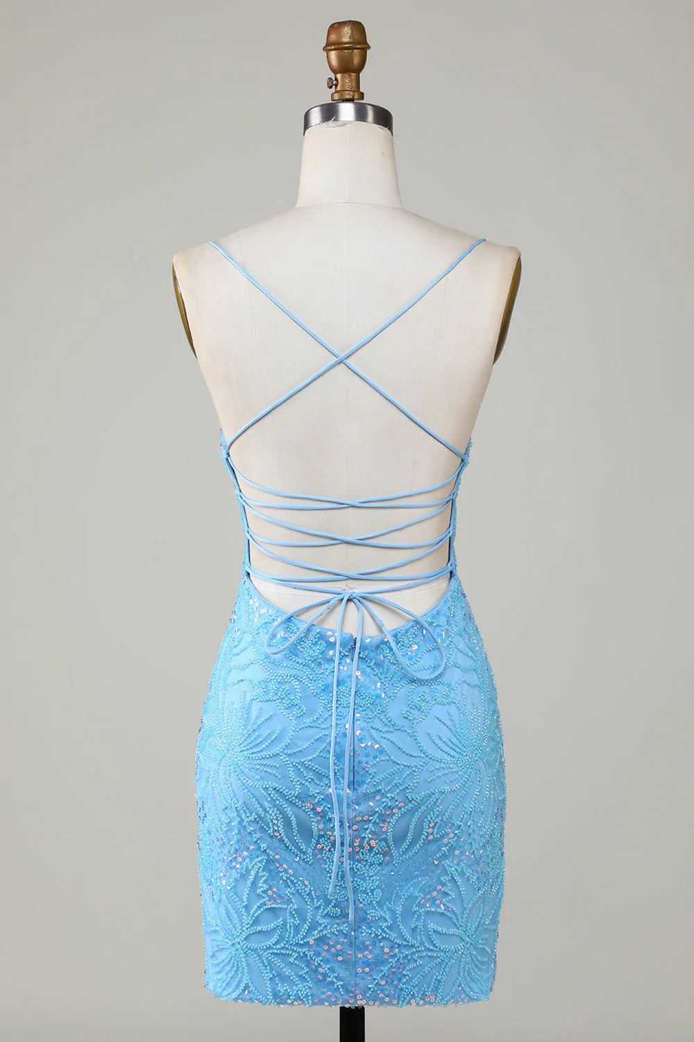 Side view of a model in a sparkly blue short homecoming dress, showcasing the fitted silhouette and beading.