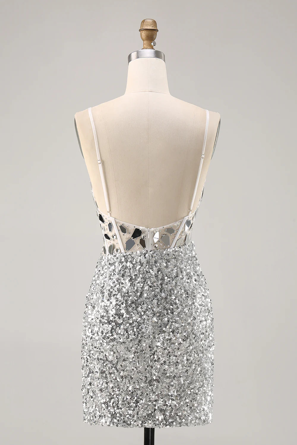 Side view of a model in a silver sequin bodycon dress with corset detail.