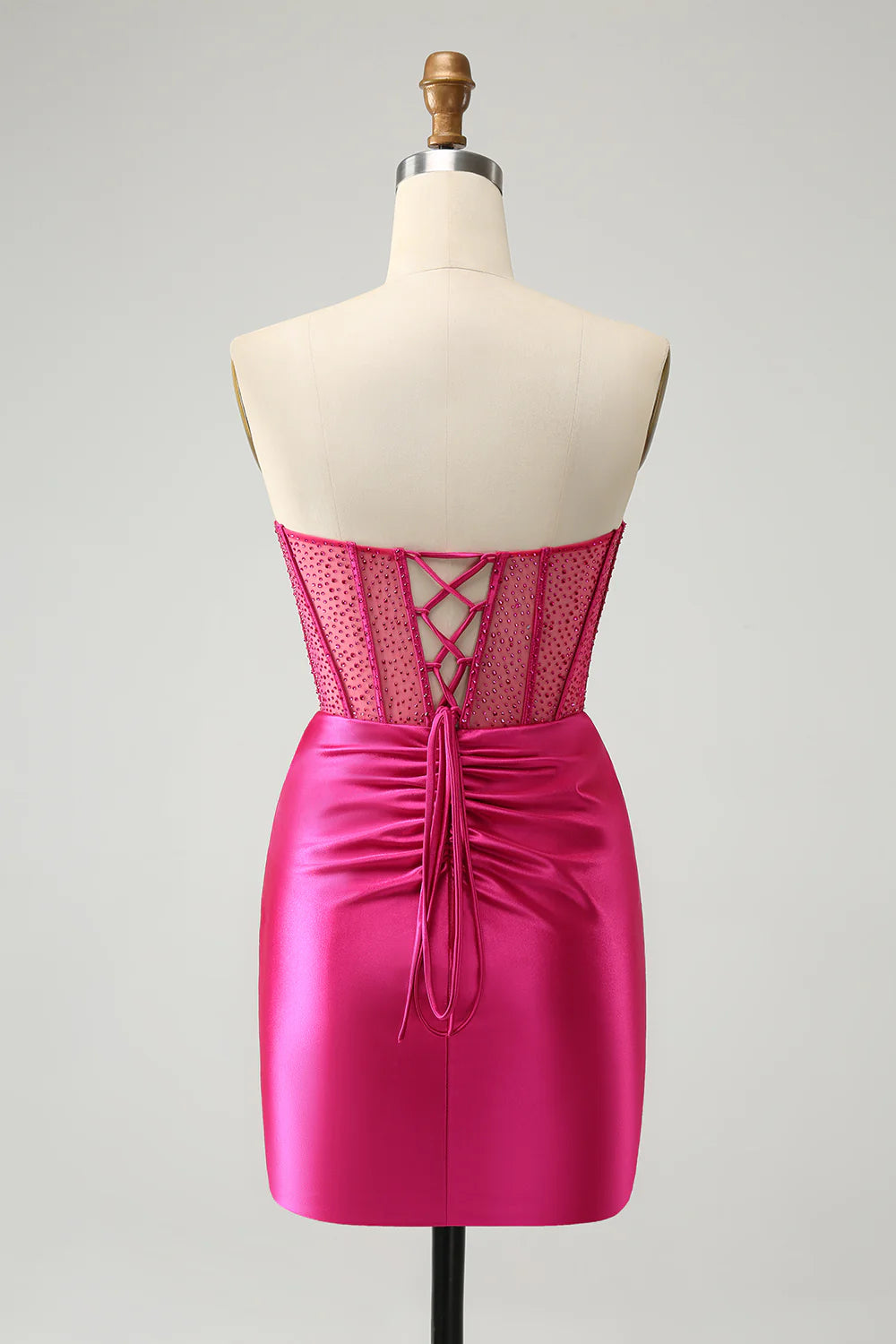 Back view of hot pink glitter strapless dress showing corset detail.