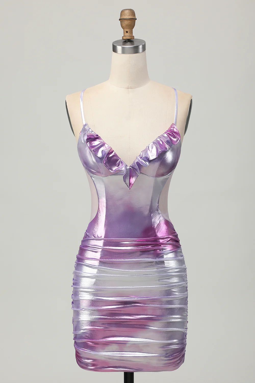 Model wearing a shimmering silver purple metallic homecoming dress with spaghetti straps and cut-out detail.