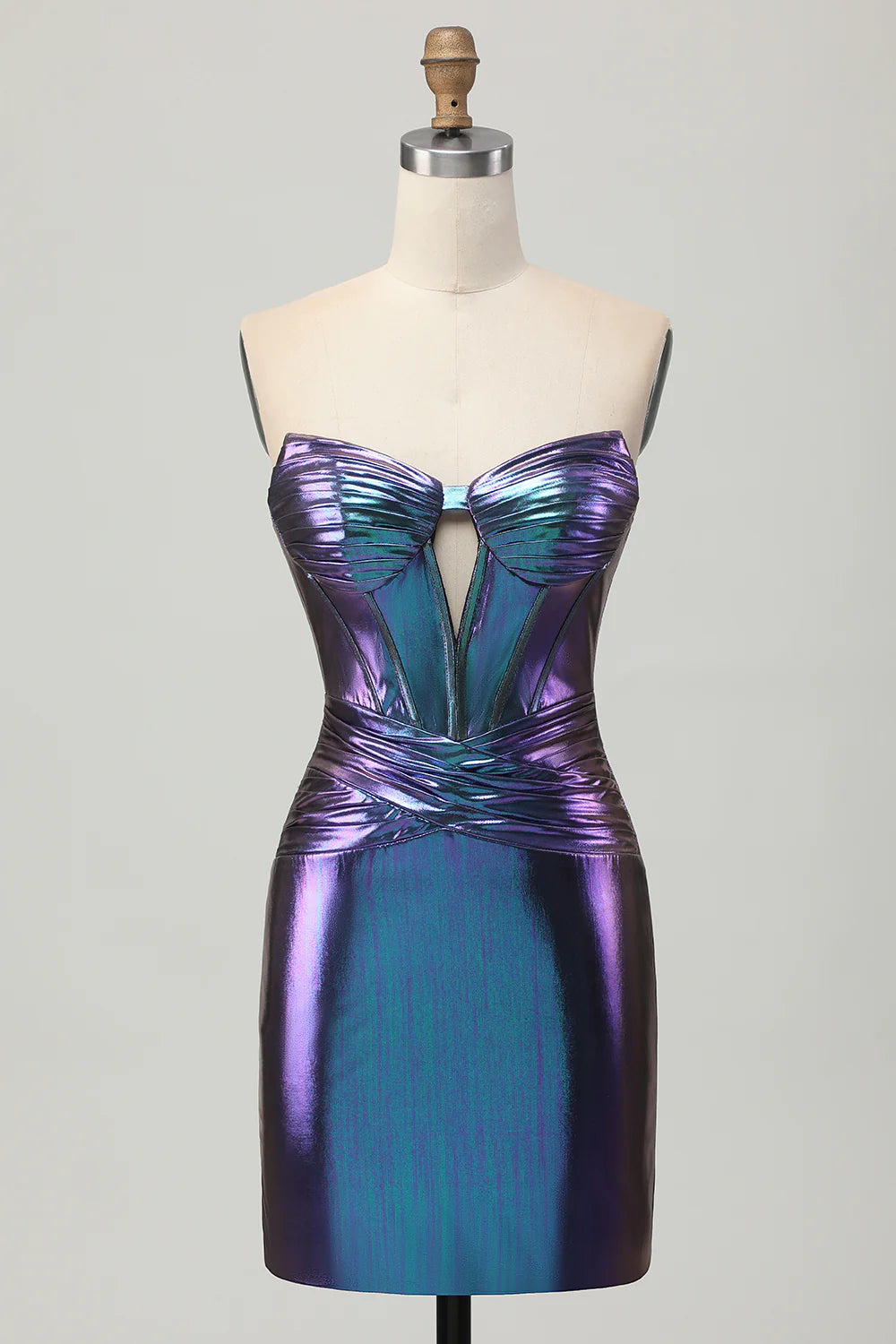 Model wearing a metallic strapless blue purple short homecoming dress with a cut-out corset bodice.