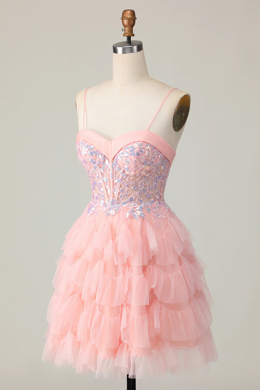 Back view of a pink tiered A-line homecoming dress with sequins and ruffles.