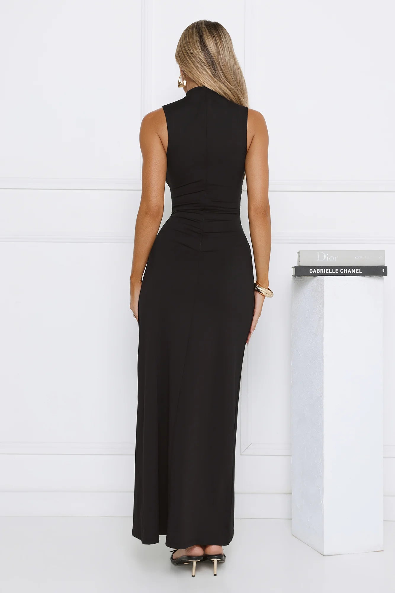 Sleek Black Sleeveless High Neck Maxi Dress with Ruched Waist Knot Detail, Form-Fitting Silhouette and Floor-Length Skirt