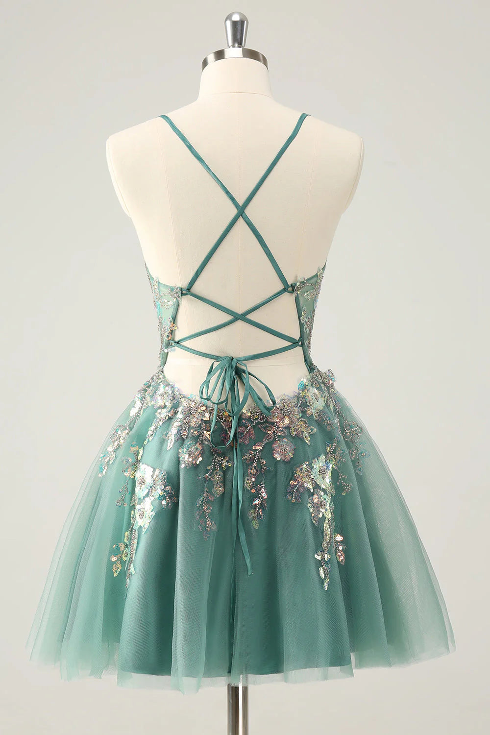 Close-up of the back of the grey-green homecoming dress, showing sequin details and spaghetti straps.