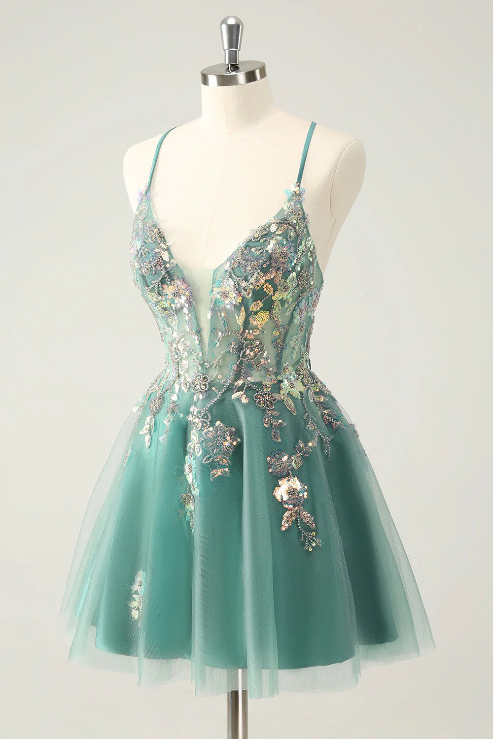 Side view of the grey-green A-line dress, highlighting the flowing skirt and sparkling embellishments.