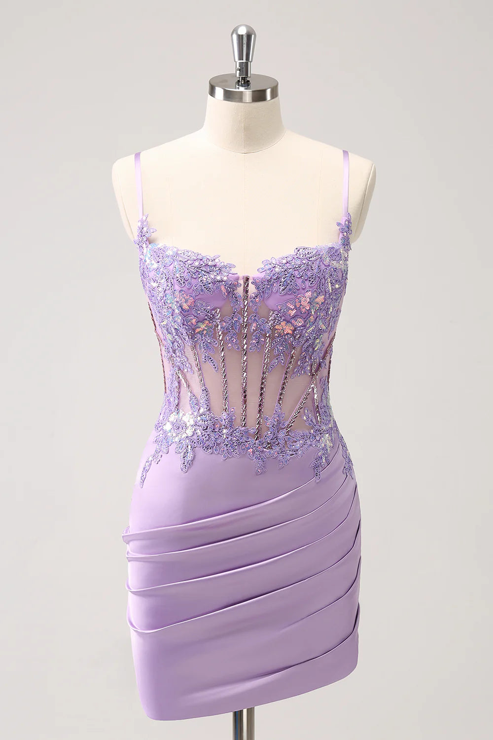 Model wearing a sparkling purple sequin A-line homecoming dress with a corset bodice.