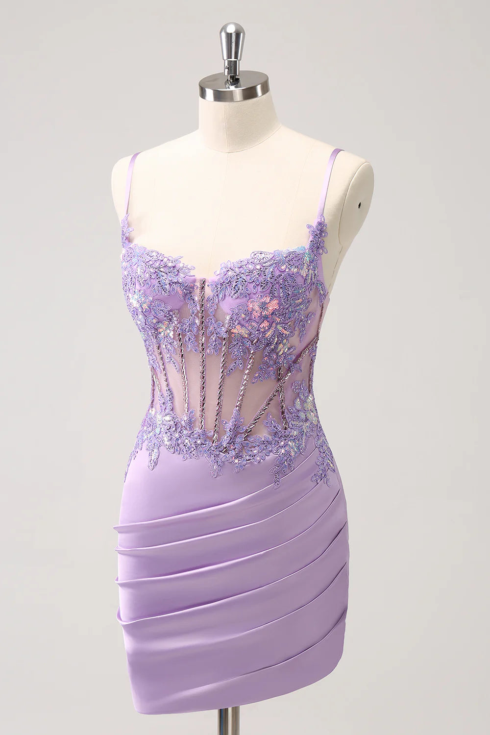 Side view of a model showcasing the pleated details of a purple sequin dress.