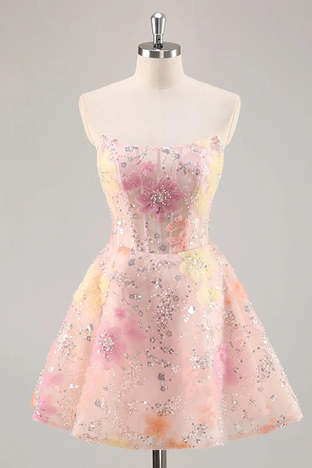 Front view of a pink A-line strapless sequin homecoming dress with a corset bodice.