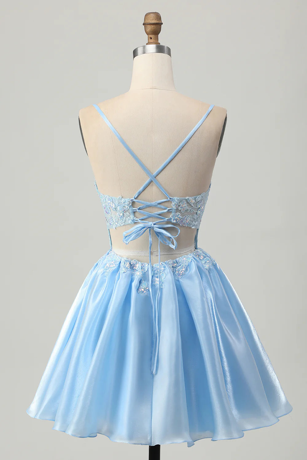 Back view of the blue sequin homecoming dress, highlighting the lace-up closure.