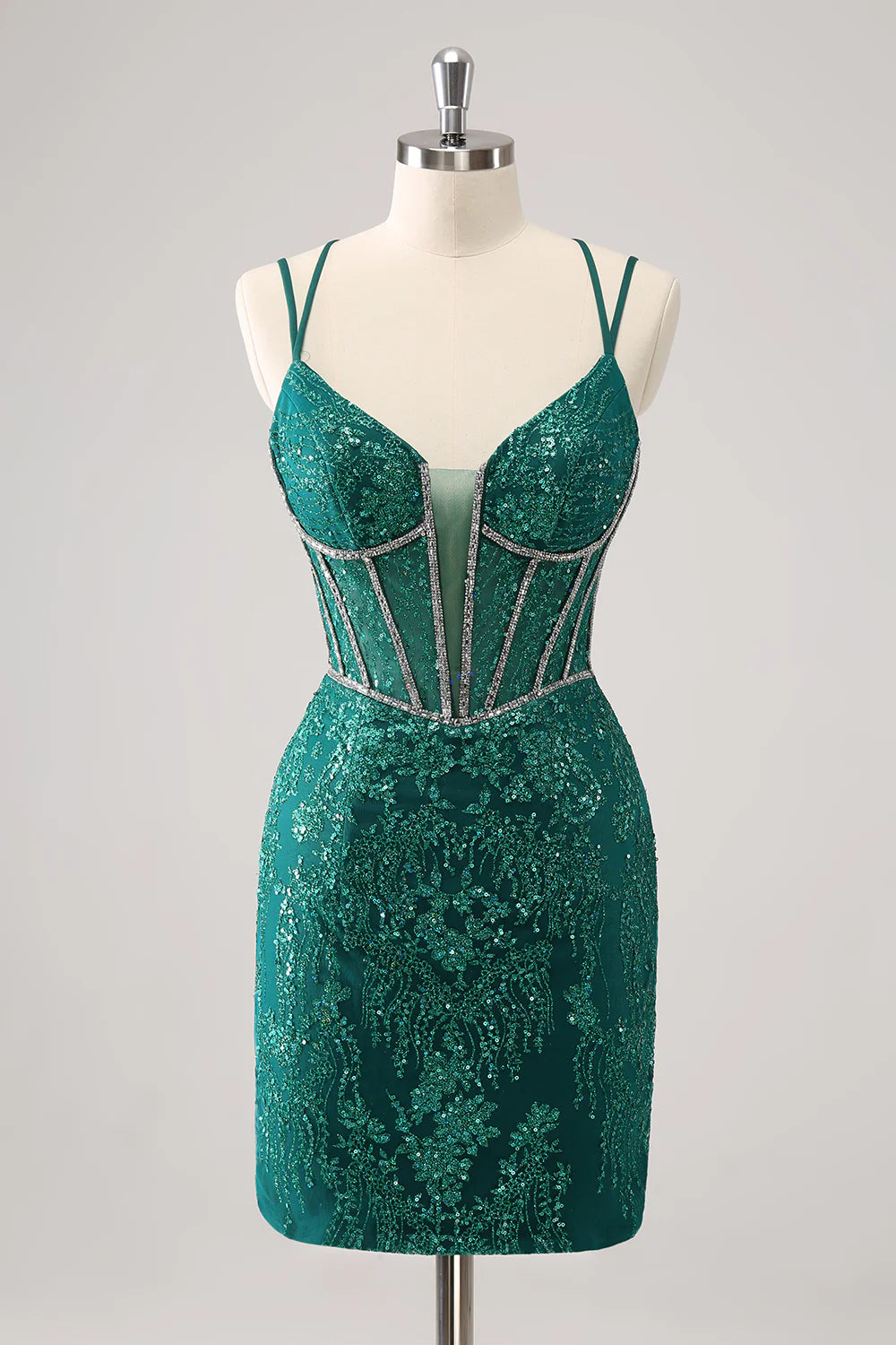 Model wearing a sparkling dark green corset short homecoming dress with spaghetti straps, front view.